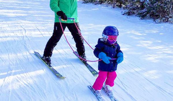 Little kid skiing with Slope Ropes Kids Ski Harness
